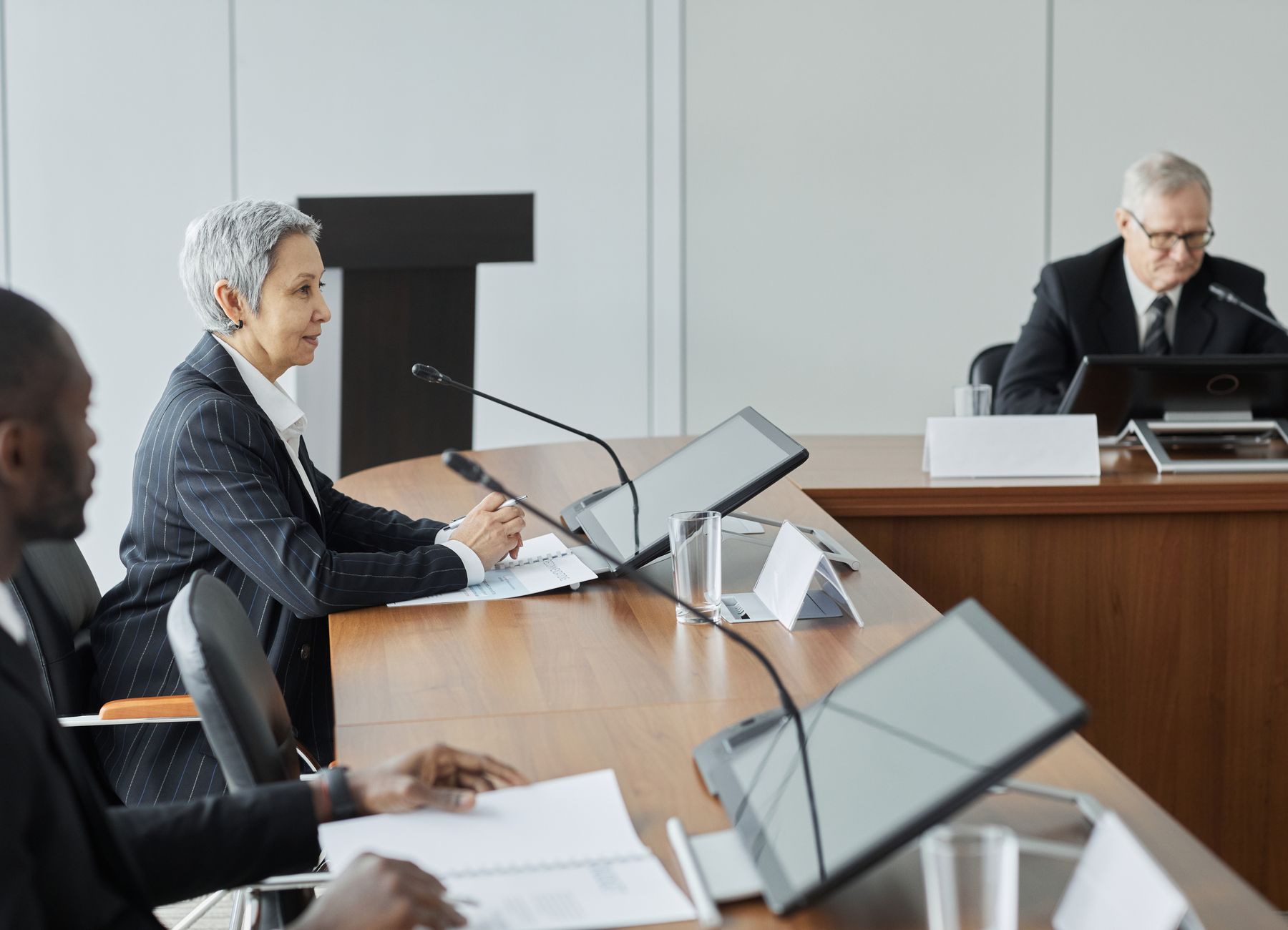 Executives in a formal roundtable discussion
